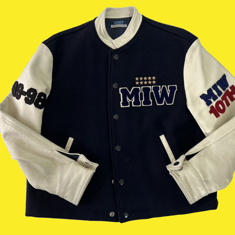 Full image of blue and white varsity jacket by Made in World.