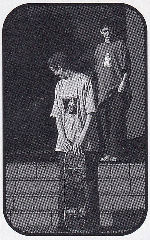 Michael 'Davo' Davidson and Ryan Denereaz standing on a set of stairs. 
    They are both wearing early 90s style skate fashion. Ryan is smiling, holding a skateboard.