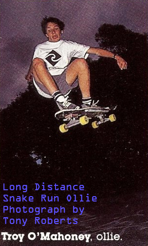 Troy is leaping a very long distance from a concrete snake run pathway over a gap into Prahran Bowl.
    Troy is wearing shorts and Vans high-top shoes. It looks as if he is floating in the air above the bowl.