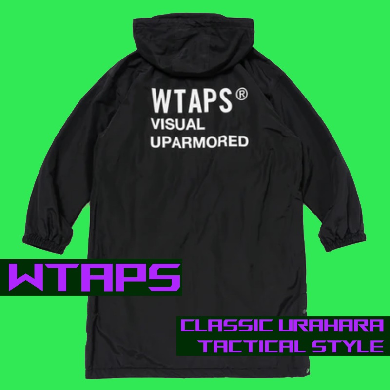 Image of a long black WTAPS trench coat style jacket with bold white print on the back reading 
    'WTAPS VISUAL UPARMORED'. The background of the image is very bright green with text reading 'WTAPS - CLASSIC URAHARA TACTICAL STYLE.' 